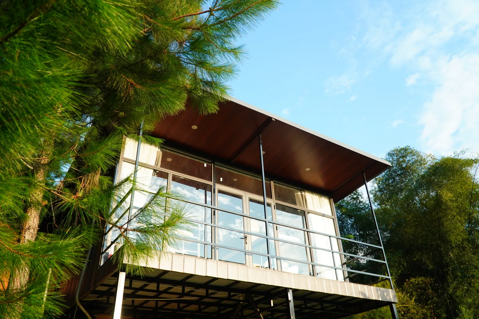 Glass-fronted stilted cabin at Jashill Homestay, Du Gia, August 2026