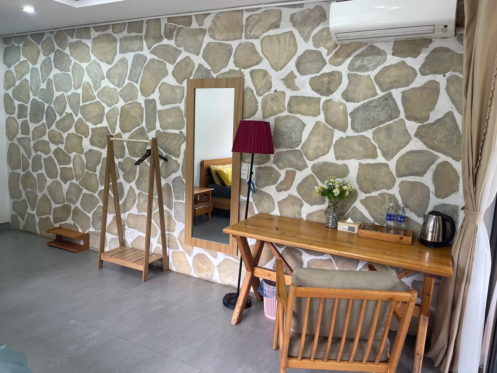 Desk, mirror and kettle in a room at Jashill Homestay, Du Gia, August 2026