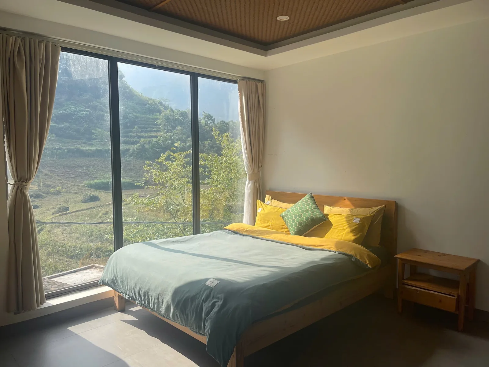Double room at Jashill Homestay with floor-to-ceiling window over the valley, Du Gia, August 2026