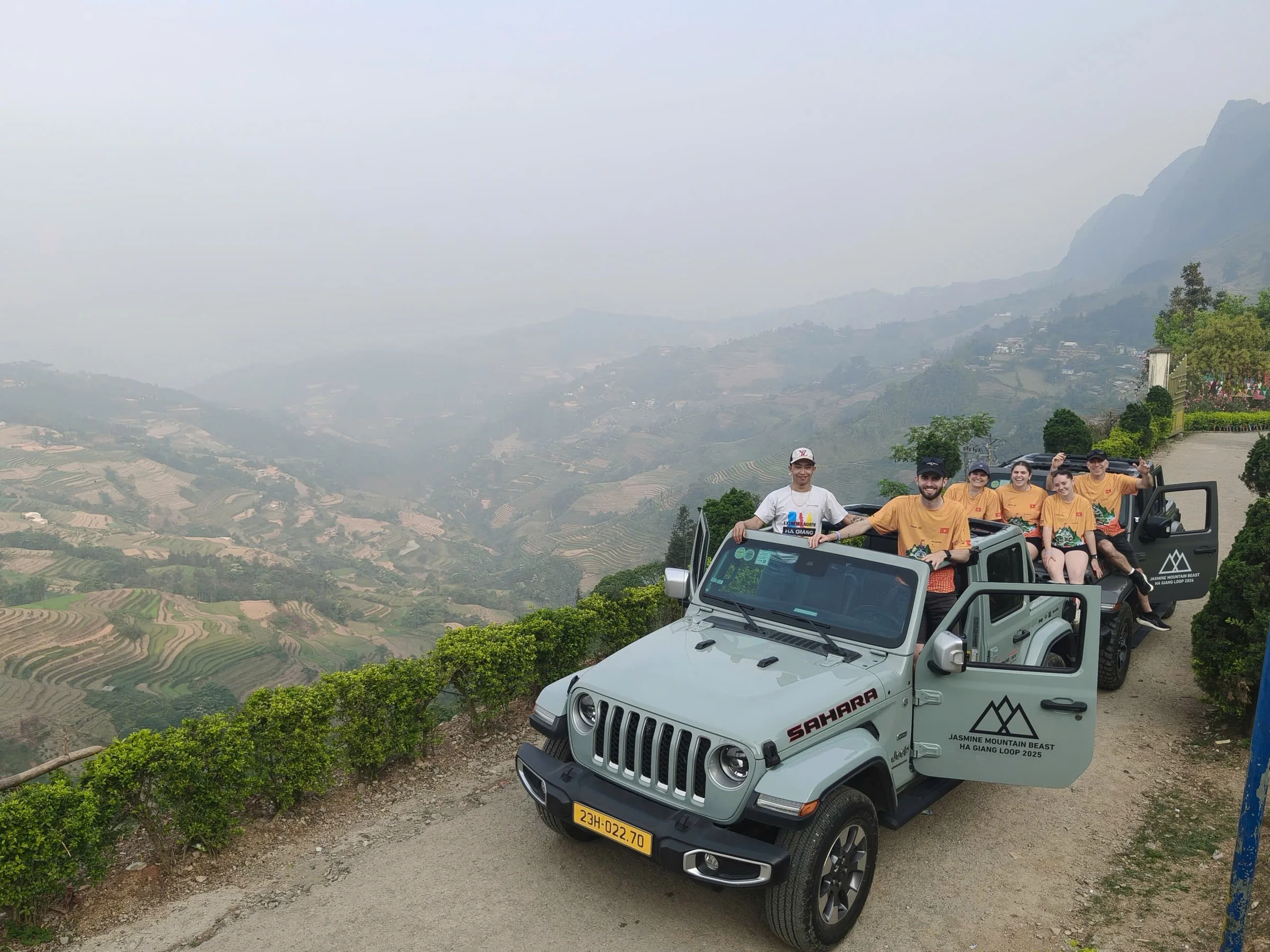 Travellers with a vehicle on a hazy mountain road in Ha Giang province, April 2026