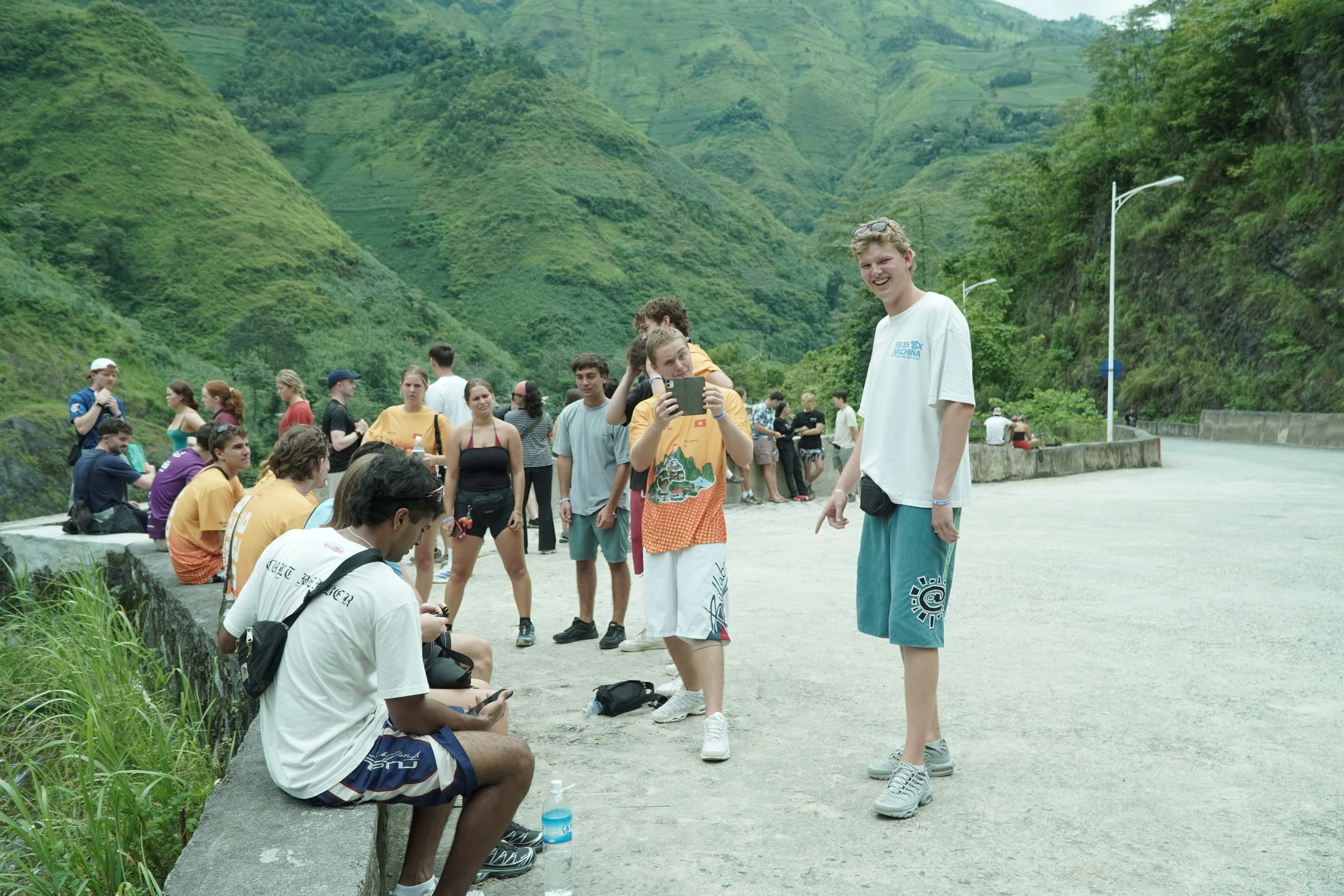 Travellers gathered at a roadside stopping point in the Ha Giang mountains