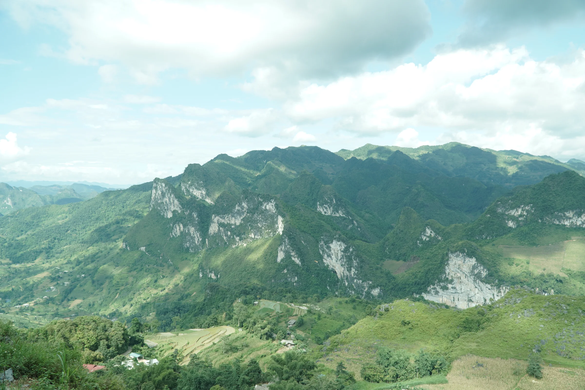 Limestone karst peaks under bright sky in Ha Giang province, dry-season conditions, July 2026