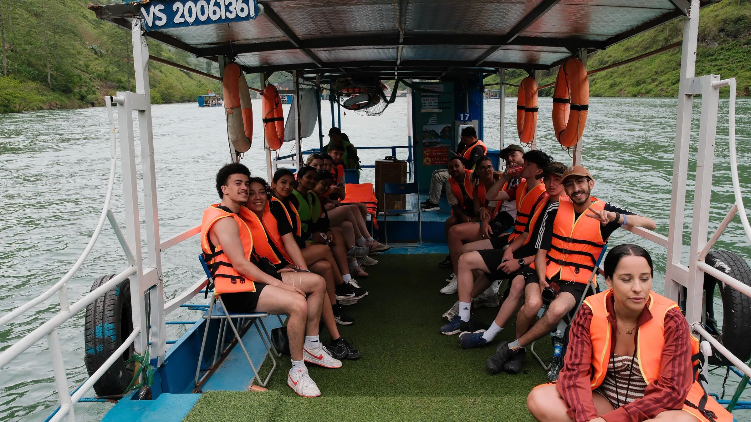 A group of travellers in life jackets seated on a boat on the Nho Que river in Ha Giang, May 2026