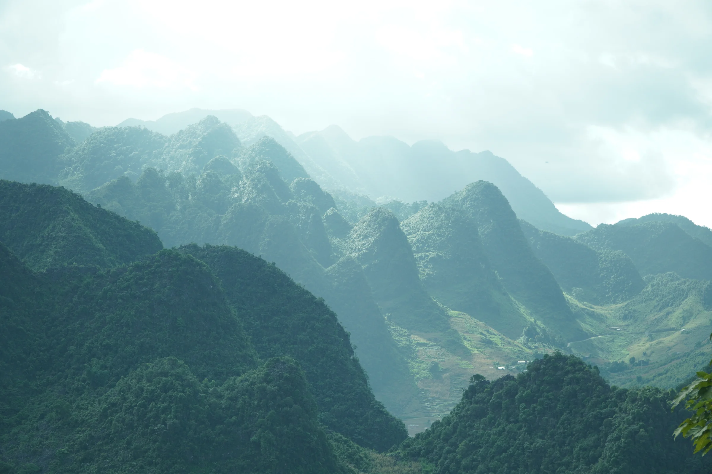 Layered mountain ridges receding into haze in the far north of Vietnam